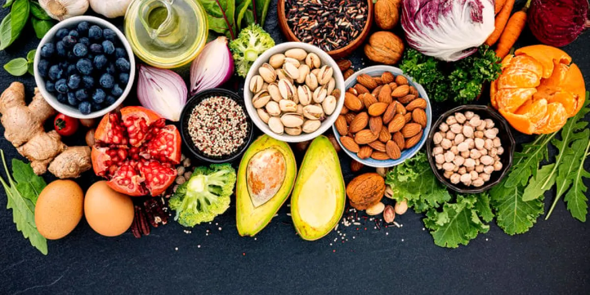 ingredients for the healthy foods selection the concept of healthy food set up on dark stone background