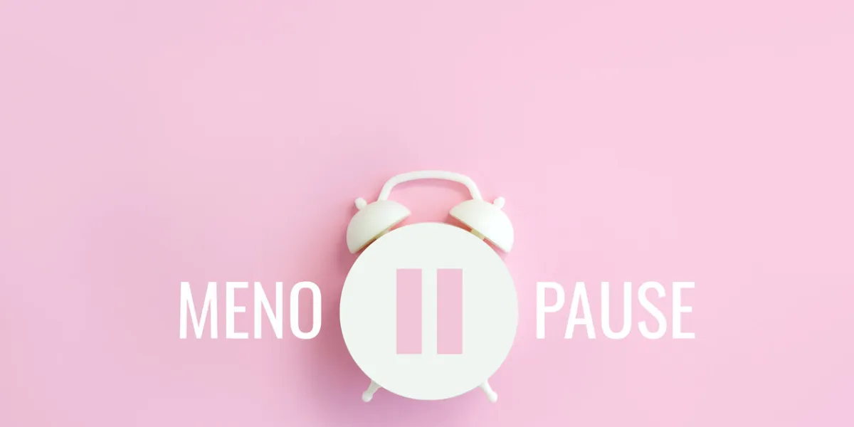 word menopause, pause sign on a white alarm clock on pink background minimal concept hormone replacement therapy Сopy space