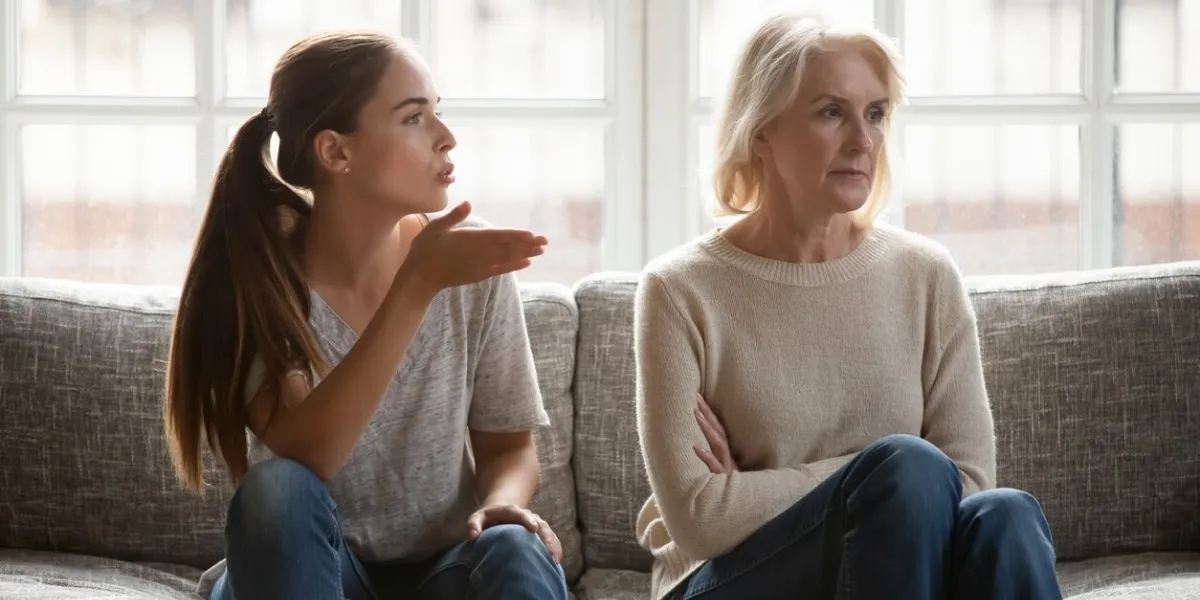 annoyed grown up daughter expressing complaints to elderly mother annoyed females sit on couch, old stubborn mom dont want make concessions, different ages, generational gap, family conflict concept