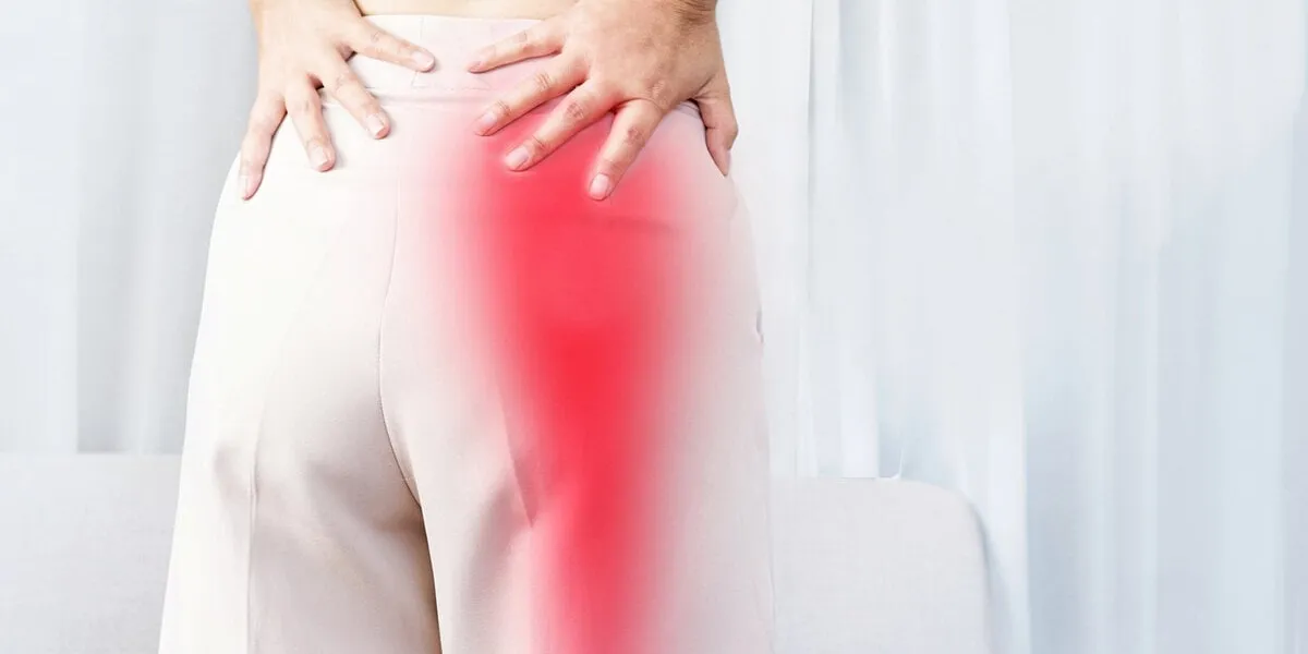 sciatica pain concept with woman suffering from buttock pain spreading to down leg