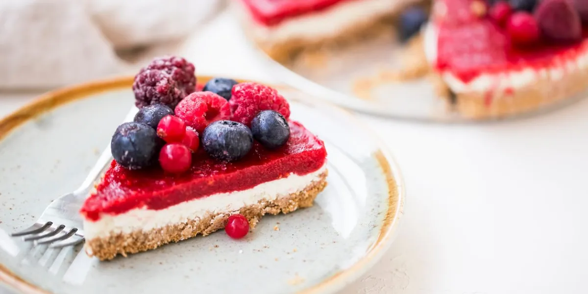 berry cheesecake slice, fresh frozen red fruits and cheese cake slice, tasty dessert
