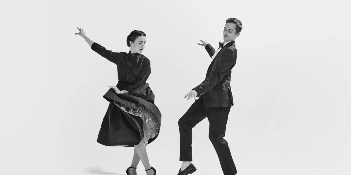 rhythmic black and white stylish, elegant young couple, man and woman in stylus clothes dancing concept of hobby, retro dance, vintage style, choreography, beauty monochrome art ad