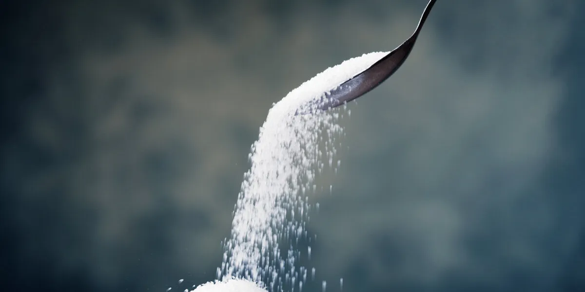 adding sugar with a spoon