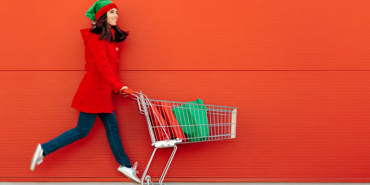 happy woman with shopping cart ready for christmas sale