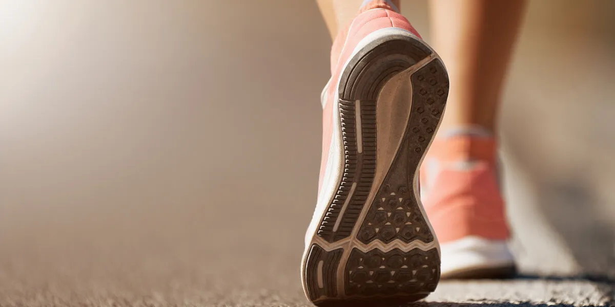 running shoe closeup of woman running on road with sports shoes