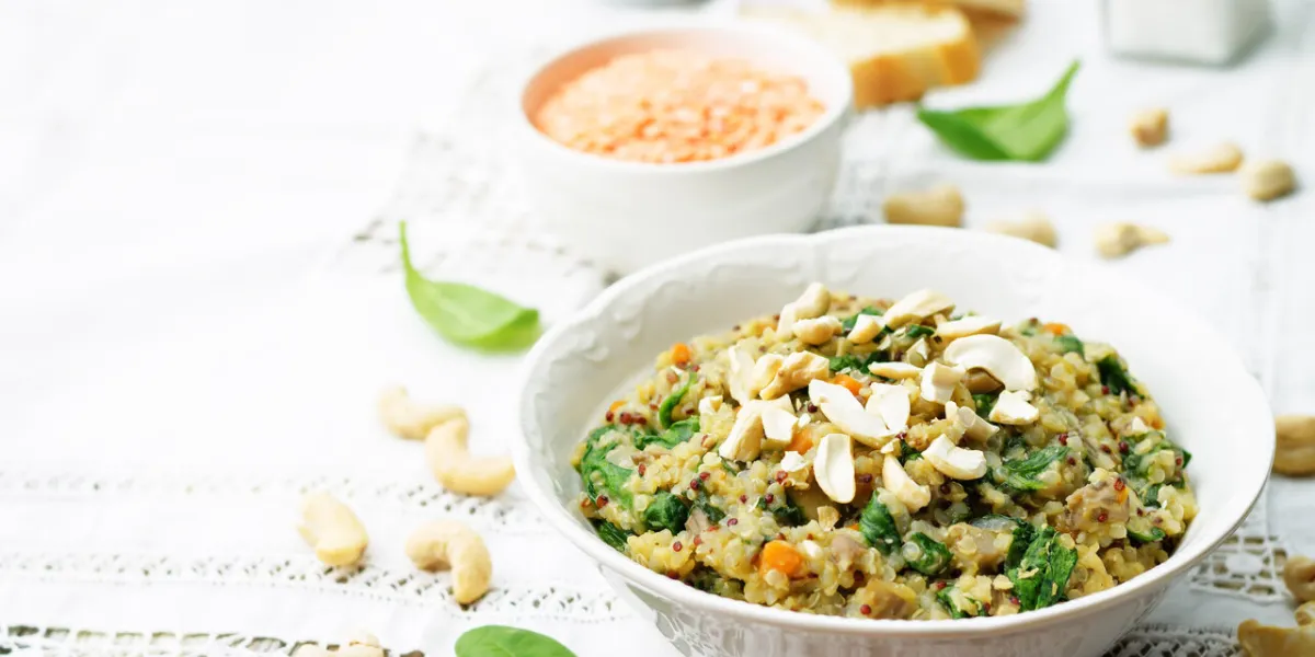 lentils mushroom spinach quinoa with fresh spinach leaves and cashews toning selective focus